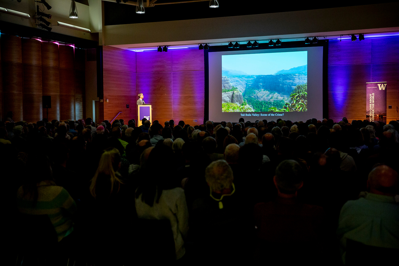 A lecture is delivered to a packed auditorium