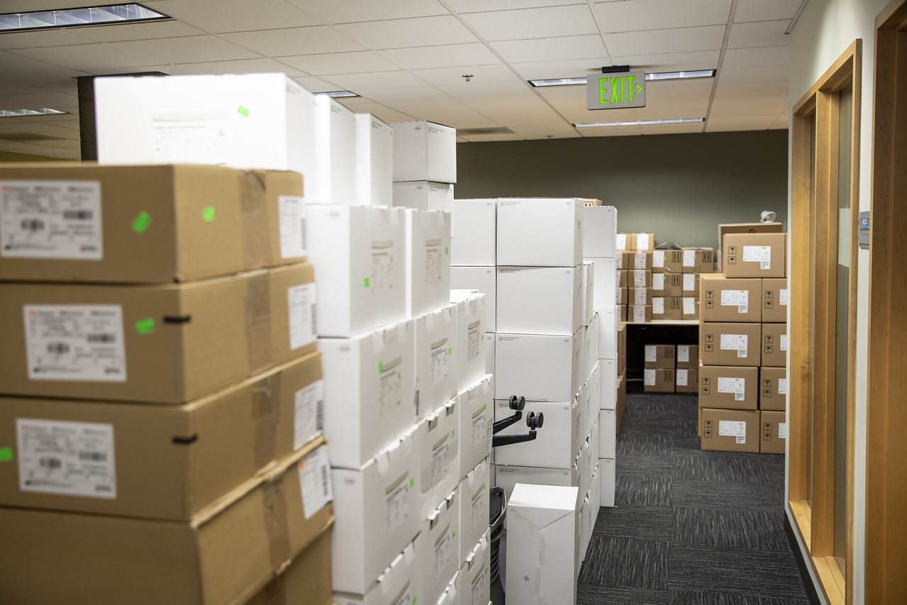 Boxes of archived material stacked high in a storage room