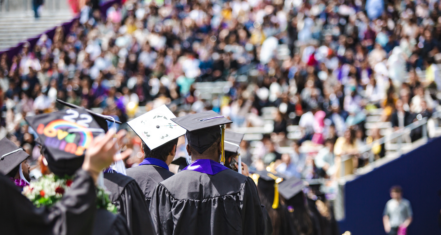 Students line up in Husky Stadium for Commencement